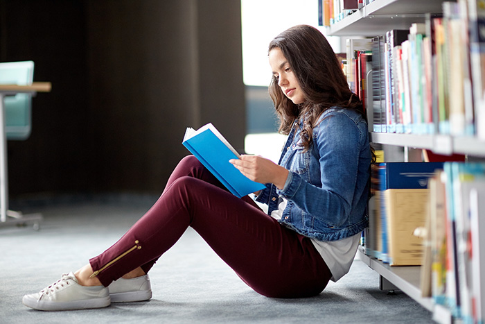 high school girl reading a book for pleasure