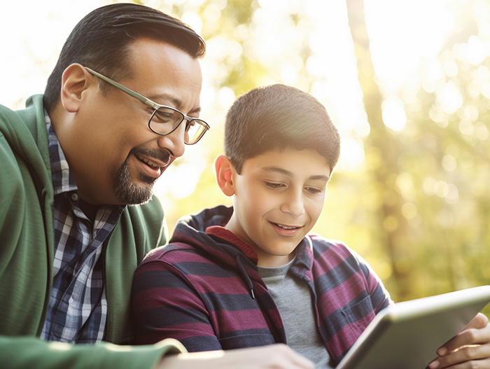 father and son reading Breakfast Serials on their tablet